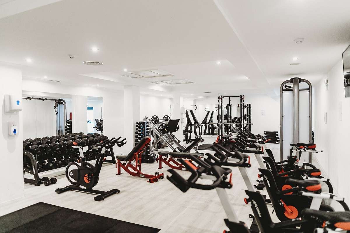 different types of gym equipment placed in a large room
