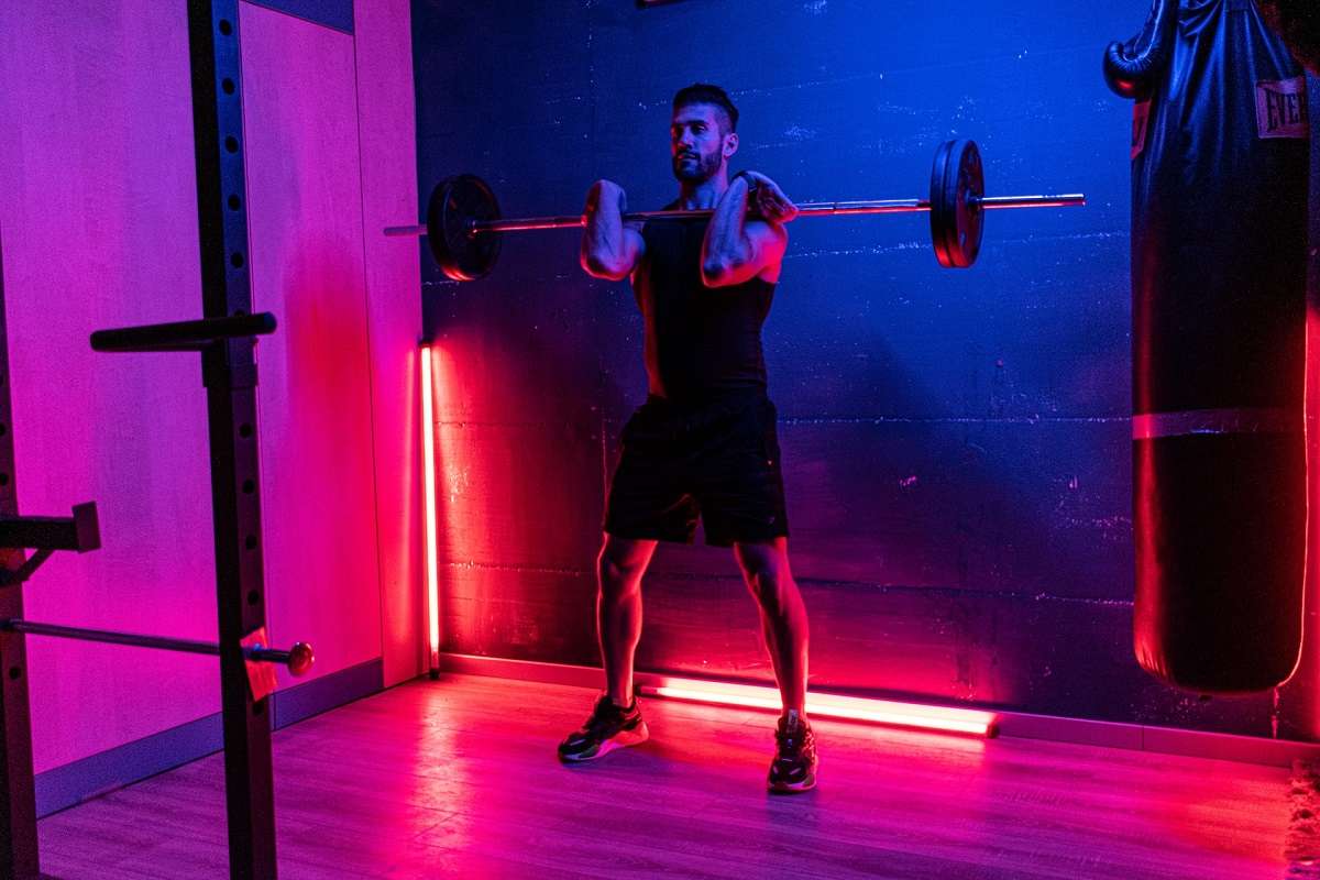 man doing workout in beautiful lighting home gym