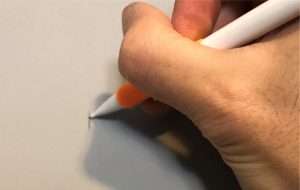 Mark the wall with a pencil